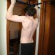 Young Guy Struggle Doing Pull-Up on Doorway Bar