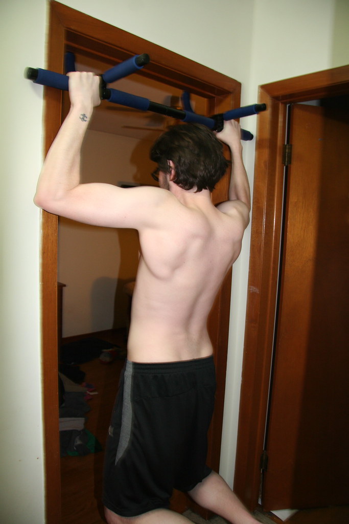 Young Guy Struggle Doing Pull-Up on Doorway Bar