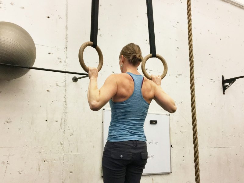 Woman Doing A Pull-Up in Rings